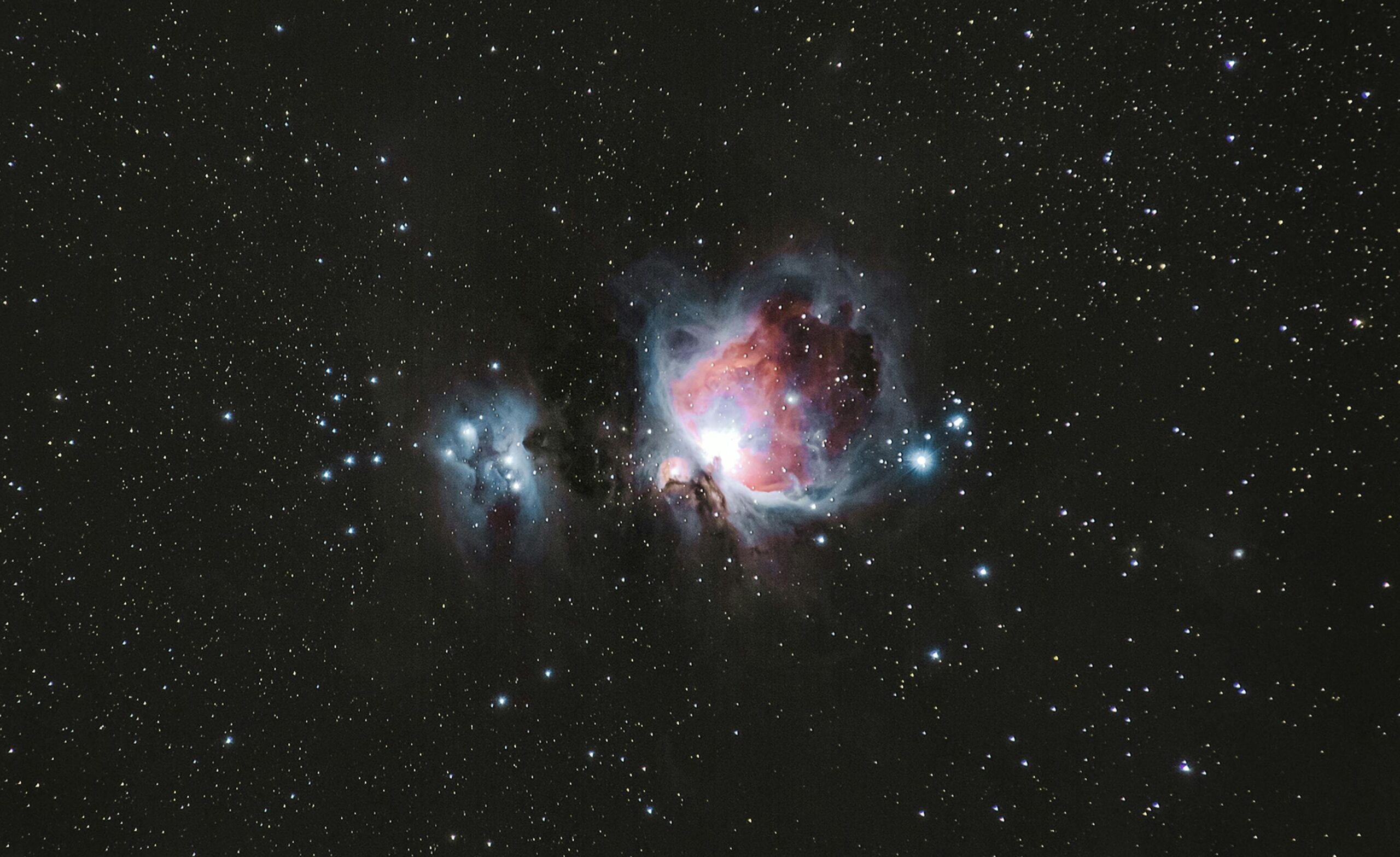 A breathtaking photograph of the Orion Nebula amidst a starry night sky, capturing celestial beauty.
